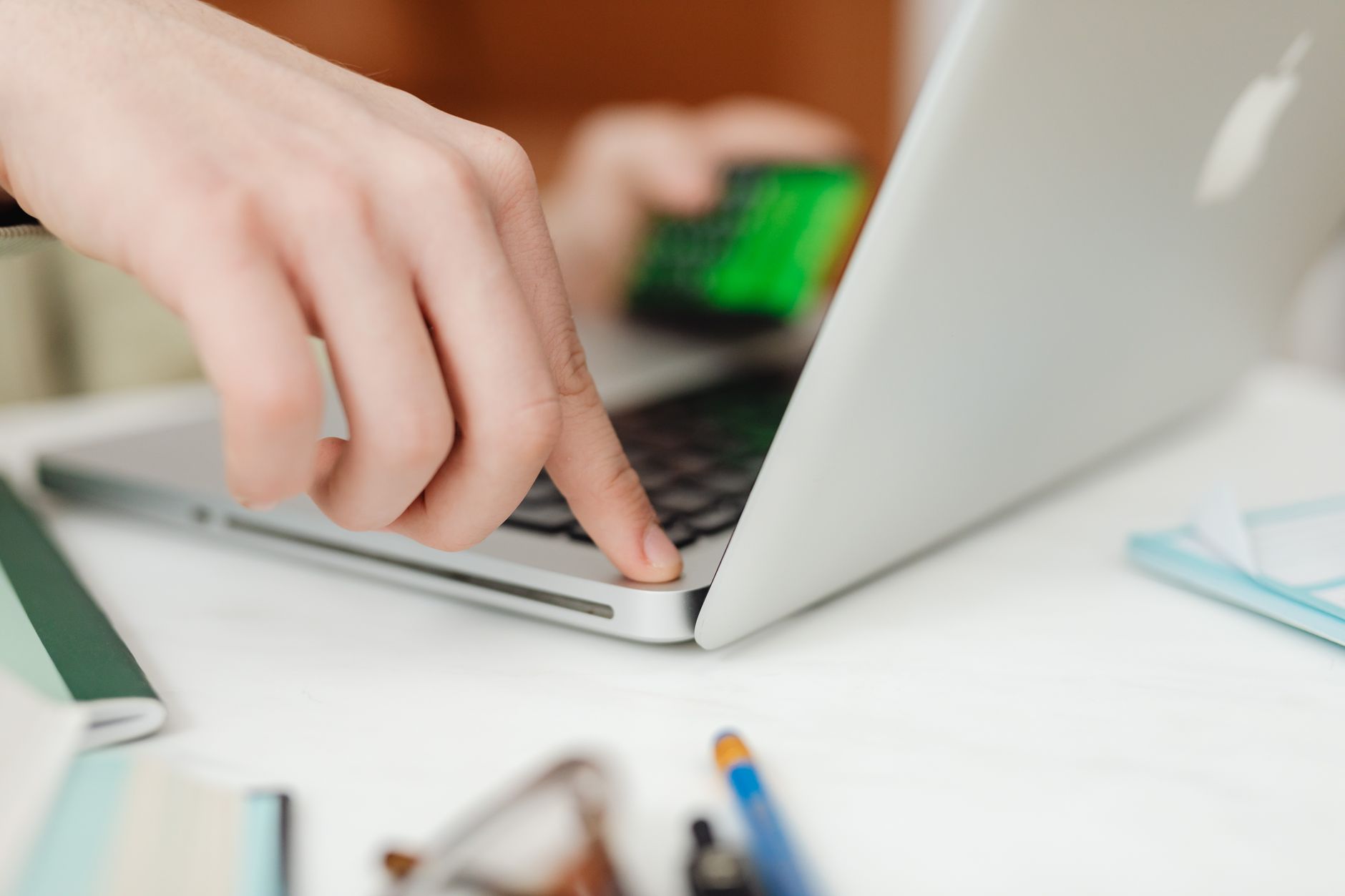Person typing on a laptop while reviewing a credit report freeze screen