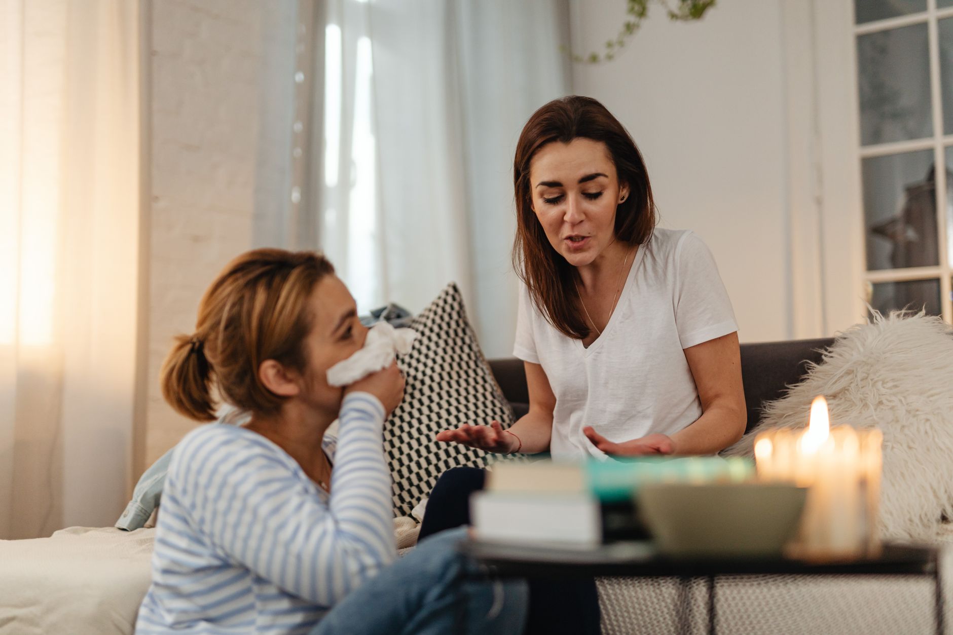 two friends having a supportive conversation in a living room