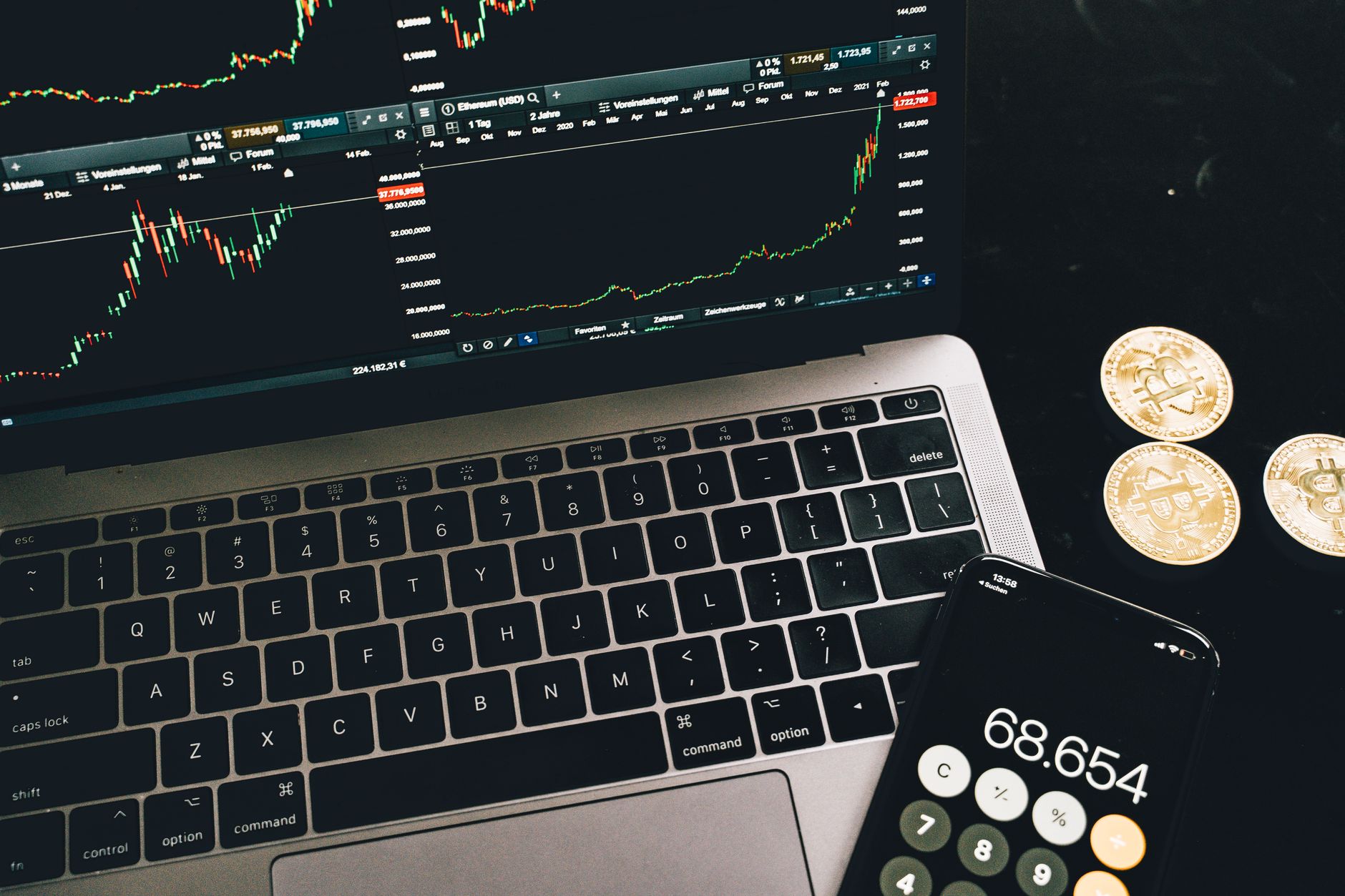 a smartphone showing a cryptocurrency wallet address string next to a laptop with a complaint form open