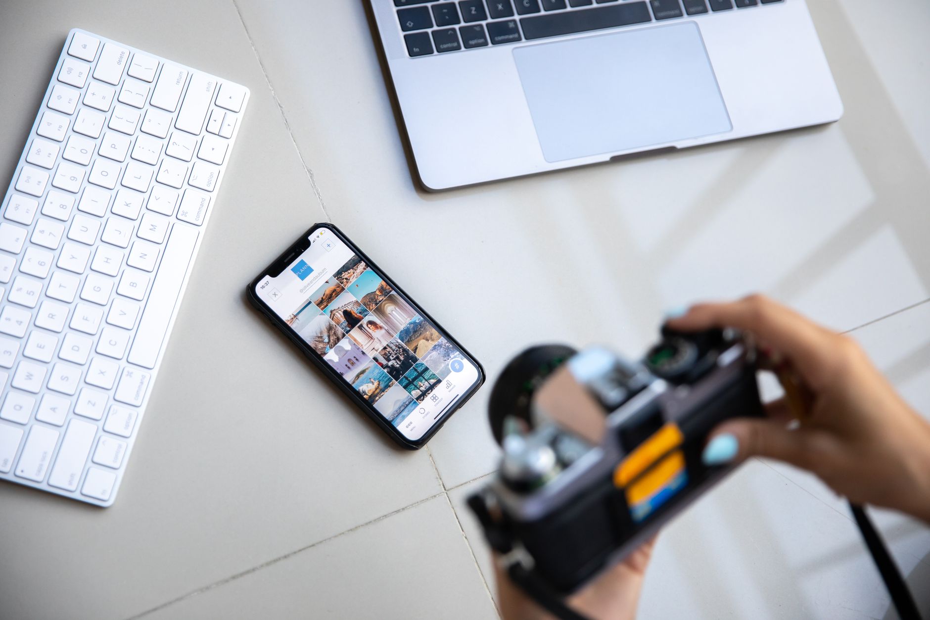 A person taking a photo of a laptop screen with a smartphone to document evidence